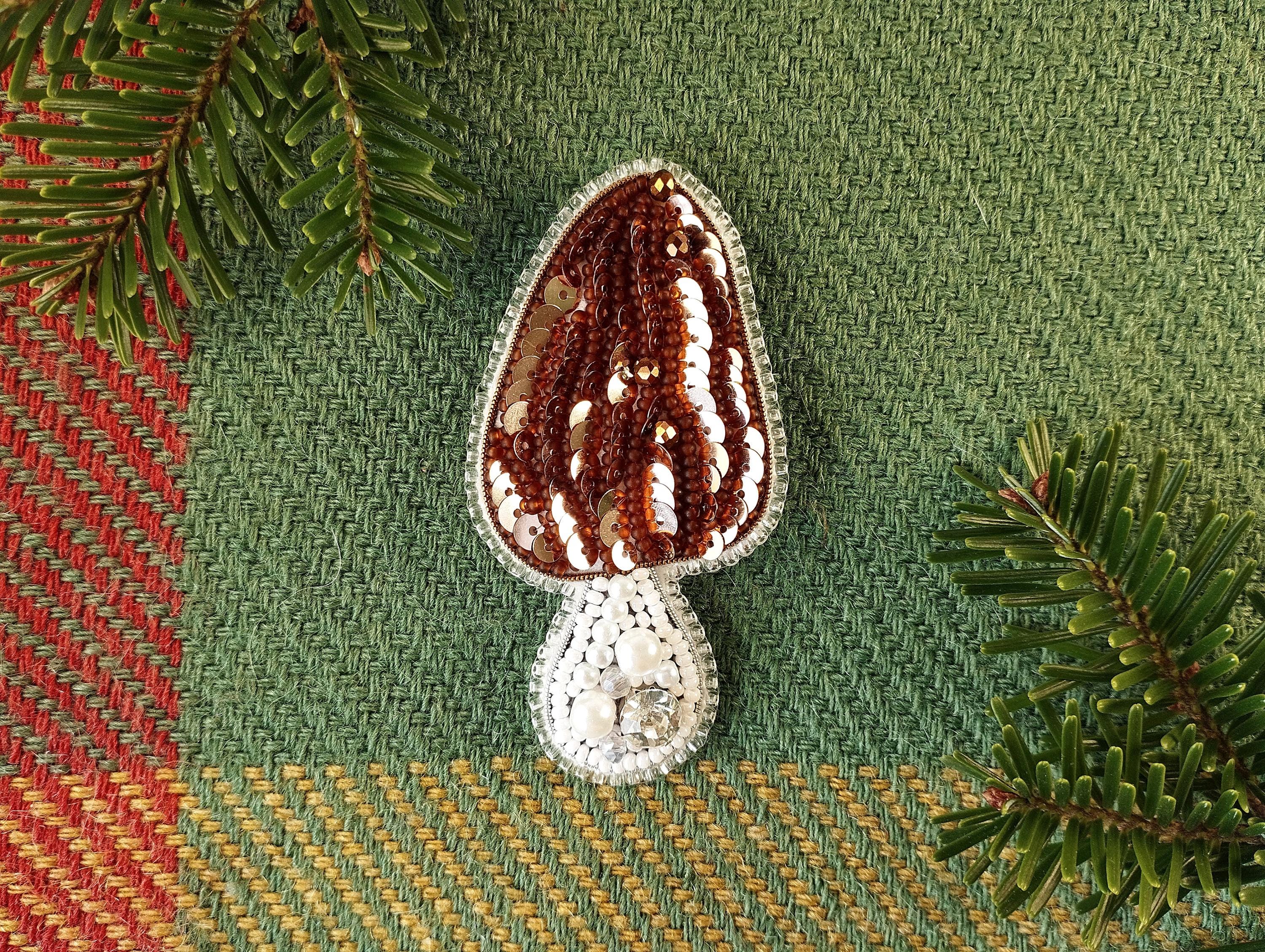 a crocheted object sitting on top of a table next to a pine tree